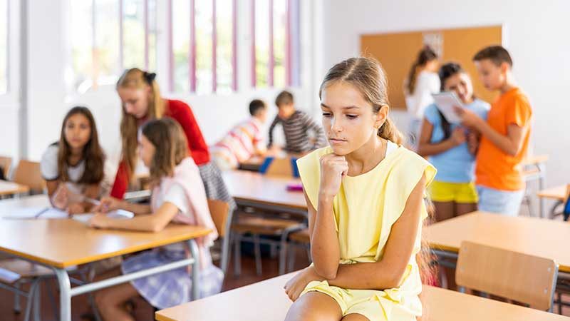 trauriges Mädchen Schulklasse